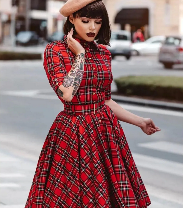 Red plaid pin-up dress with belt worn on city street